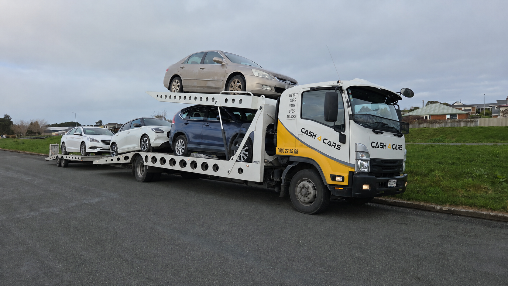 Cash4Cars Southland transporter loaded with four cars ready for removal